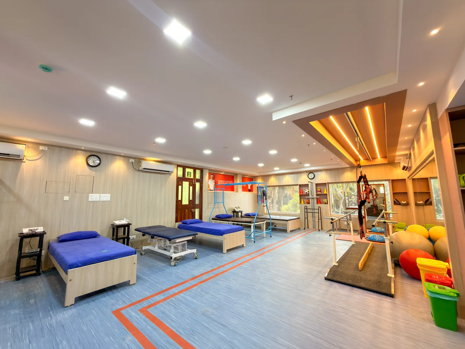 Spacious physiotherapy gymnasium equipped for active motor and balance rehabilitation Biomechanical physiotherapy gymnasium with dynamic balance and strength equipment