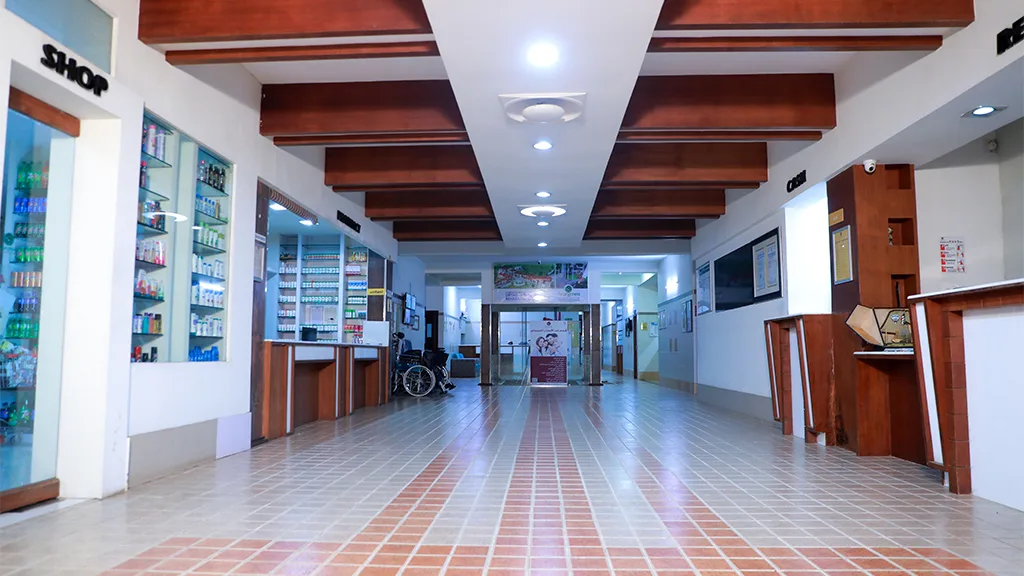 Sunlit hospital grand lobby warmly welcoming patients and international families Airy sunlit grand reception lobby and welcoming atrium at Ayurgreen Hospital